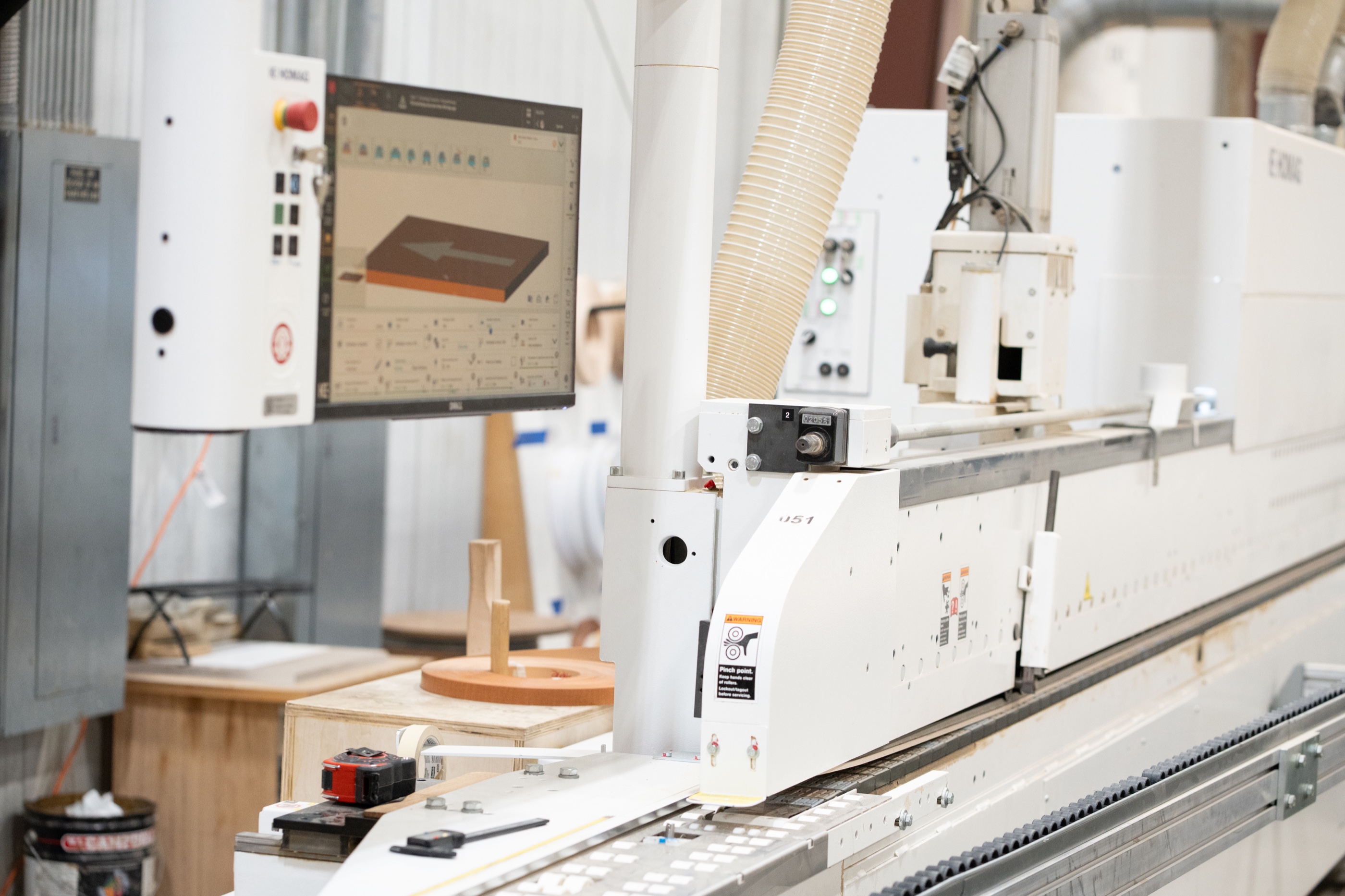 Computer-controlled woodworking equipment on the Showbest production floor