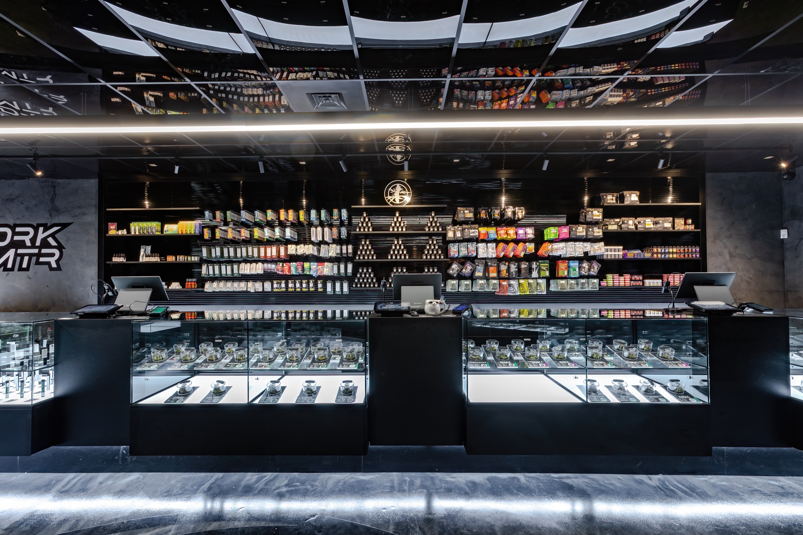Black illuminated retail fixtures at DRK MTR